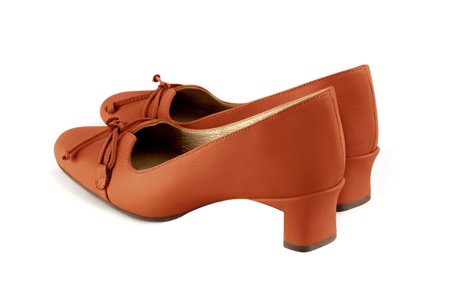 French elegance and refinement for these clementine orange dress pumps, with a knot on the front, 
                available in many subtle leather and colour combinations. With its original cut, this pretty low-heeled pump
will serve you well, combining comfort and distinction. 
                Matching clutches for parties, ceremonies and weddings.   
                You can customize these shoes to perfectly match your tastes or needs, and have a unique model.  
                Choice of leathers, colours, knots and heels. 
                Wide range of materials and shades carefully chosen.  
                Rich collection of flat, low, mid and high heels.  
                Small and large shoe sizes - Florence KOOIJMAN